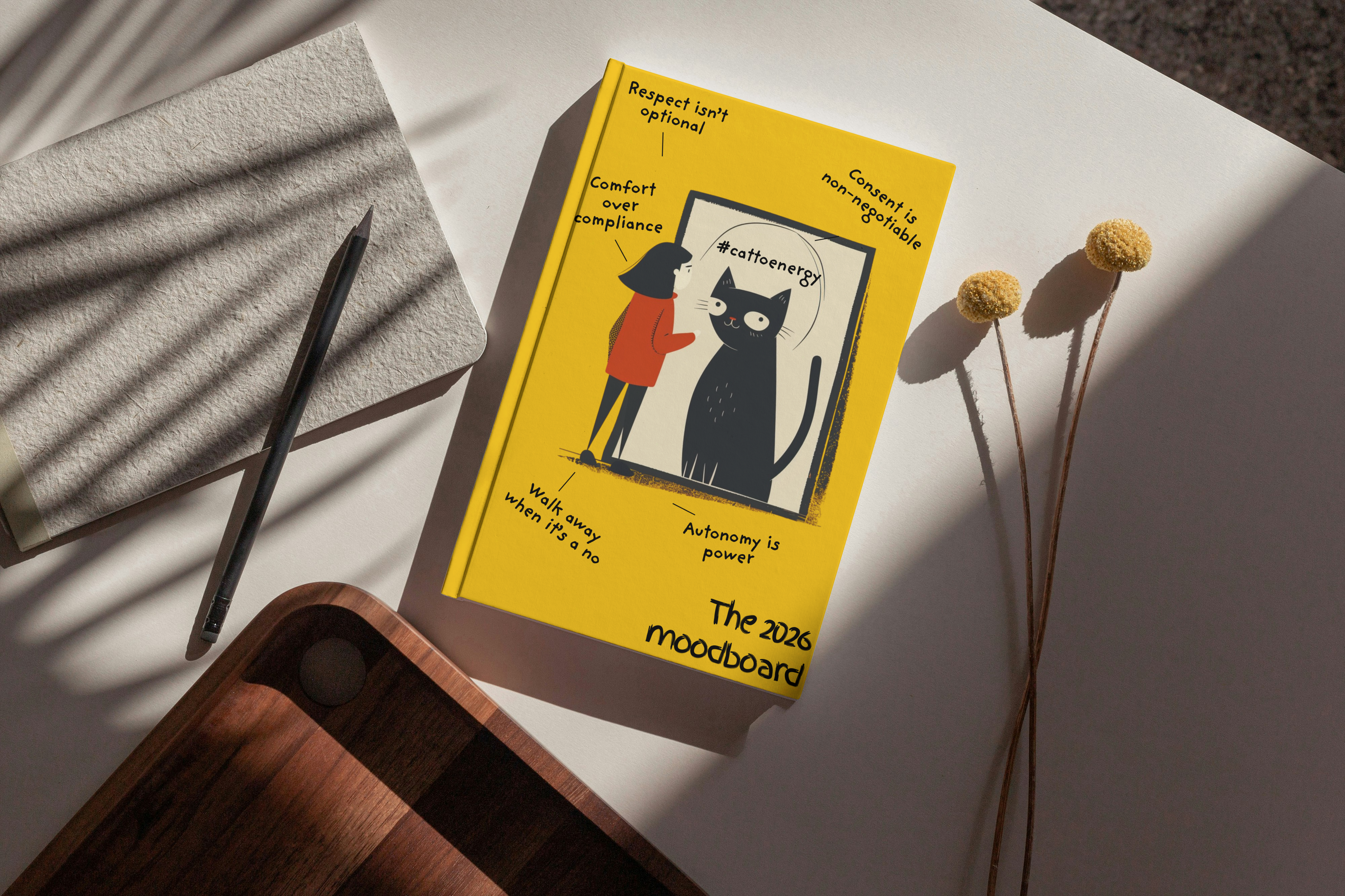 Book titled 'The 2020 Moodboard' with a yellow cover featuring a black cat illustration on a white surface.