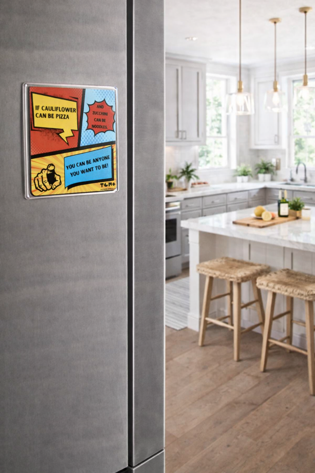 Modern kitchen with a refrigerator and a colorful magnet on it.