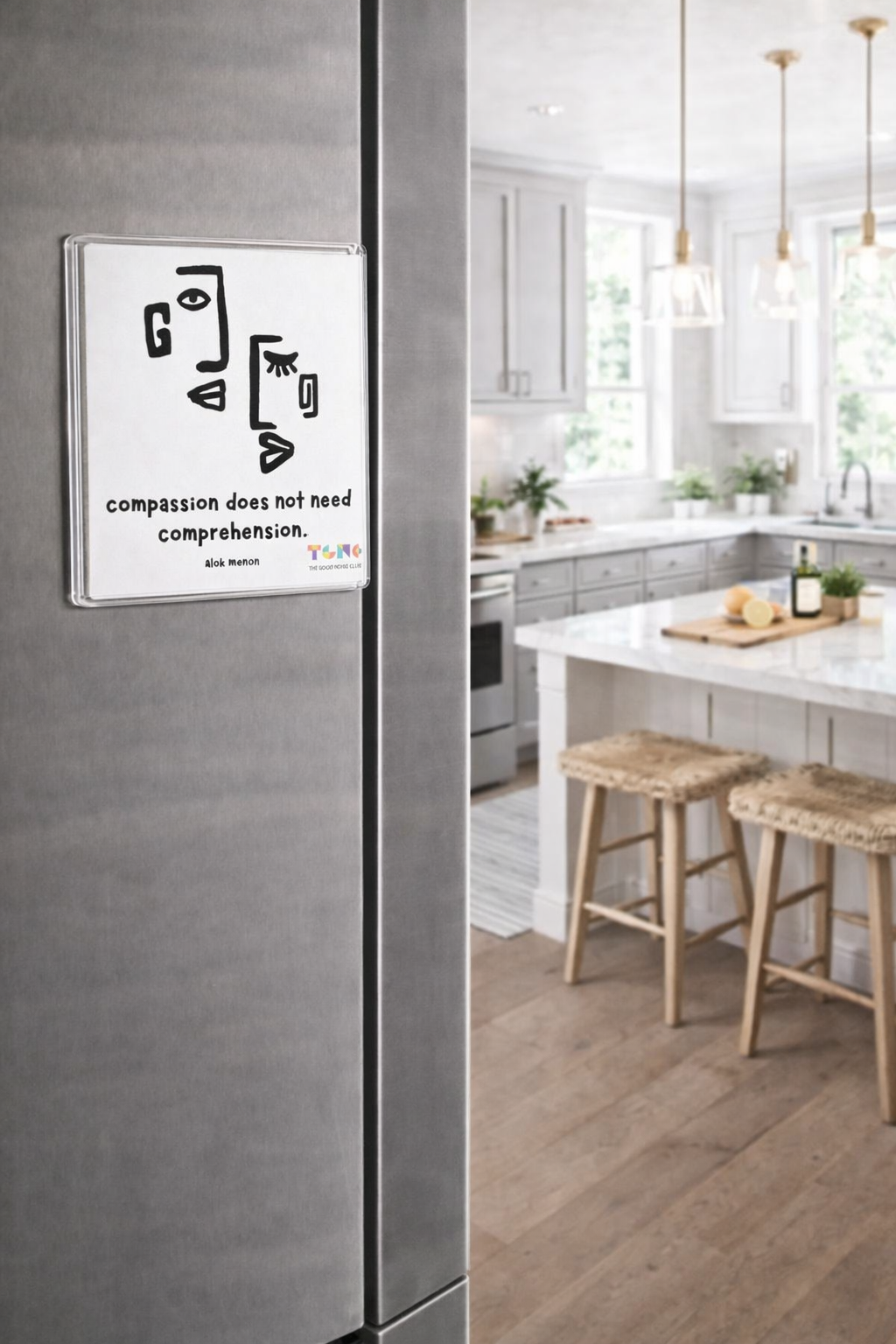 Modern kitchen with a refrigerator featuring a motivational quote.