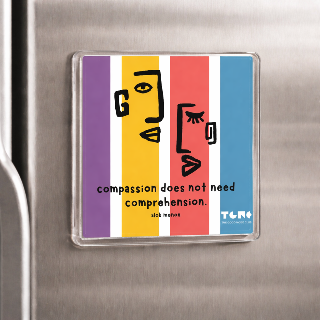 Colorful magnet with a face design and text on a metallic surface