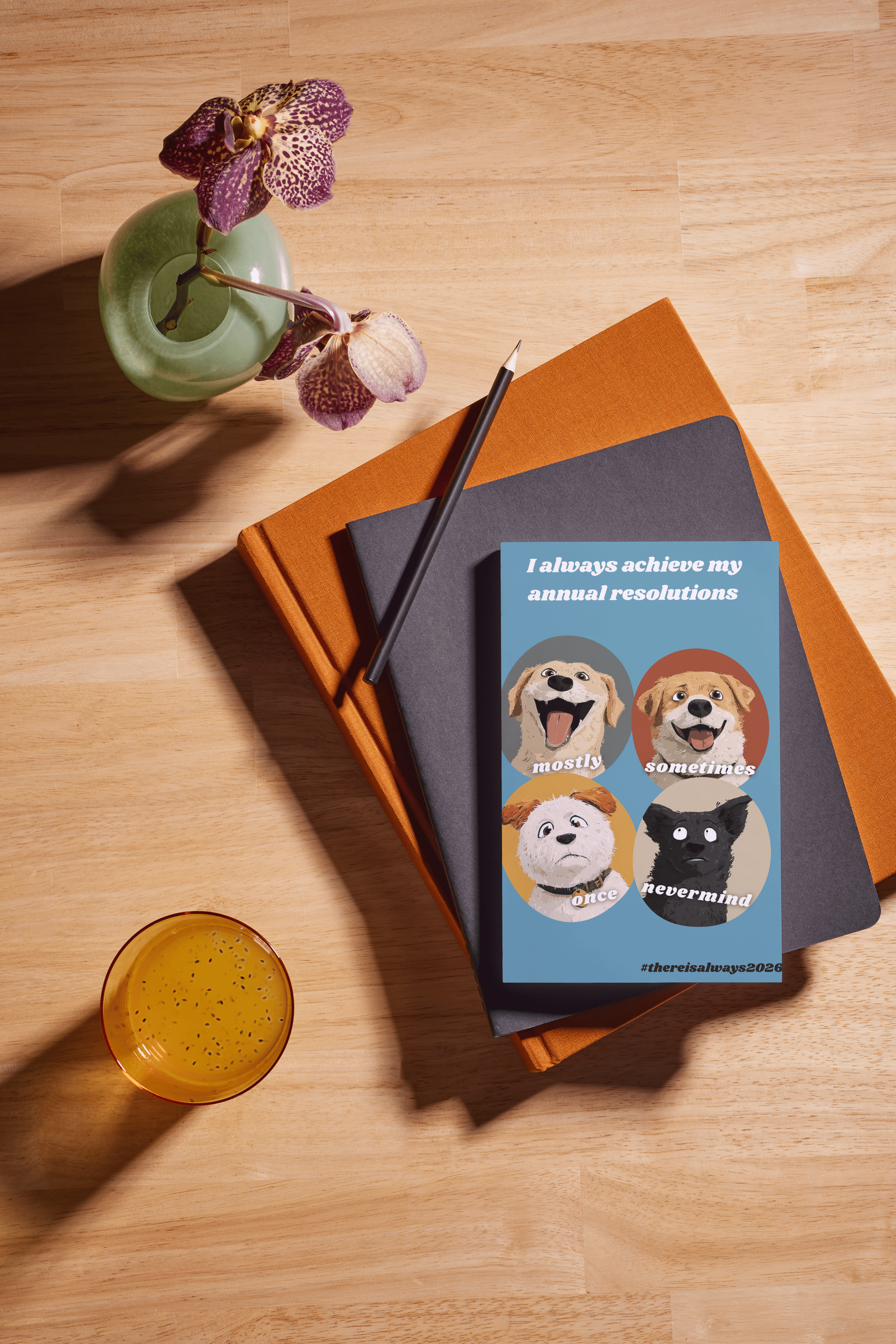 Notebooks with a motivational card featuring cartoon dogs on a wooden surface with a drink and flowers.
