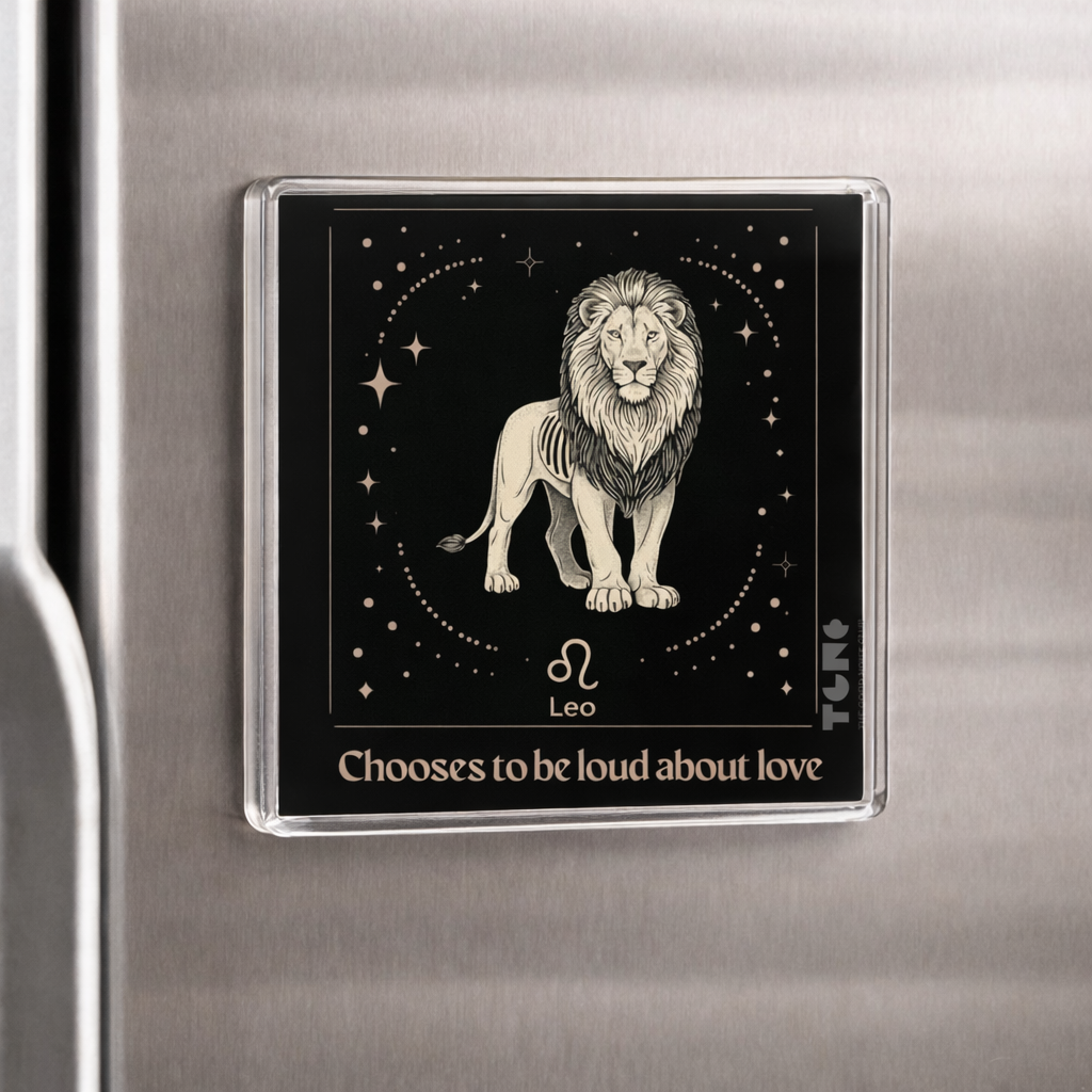 Fridge magnet with a lion illustration and text on a metallic surface