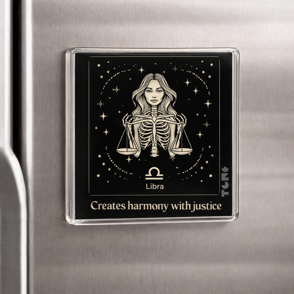 Fridge magnet with Libra zodiac design on a metallic surface