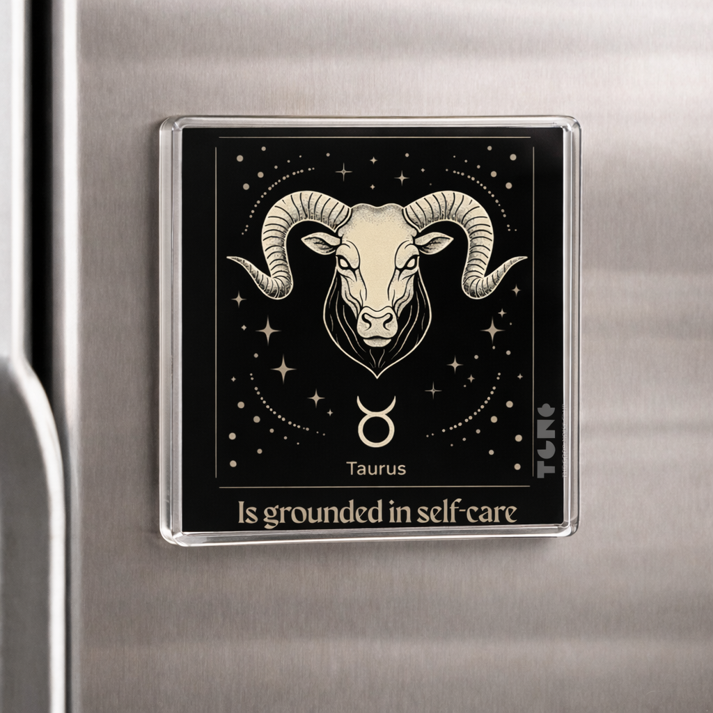 Fridge magnet with Taurus zodiac sign and text on a metallic surface